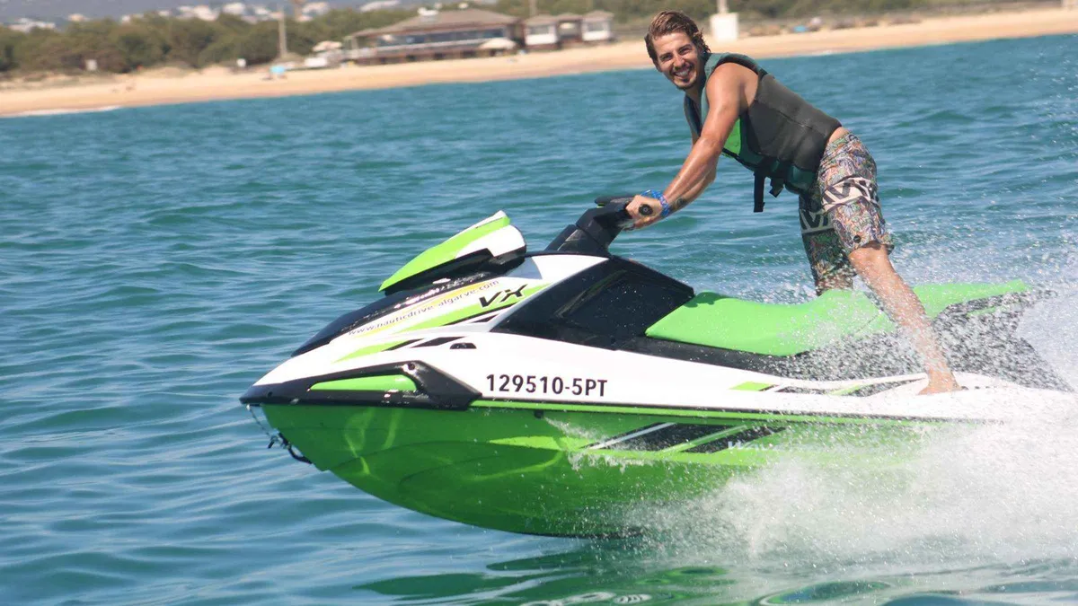Jet ski throwing spray across the water off Rocha Baixinha beach near Albufeira, a short adrenaline option among things to do in Albufeira, Algarve